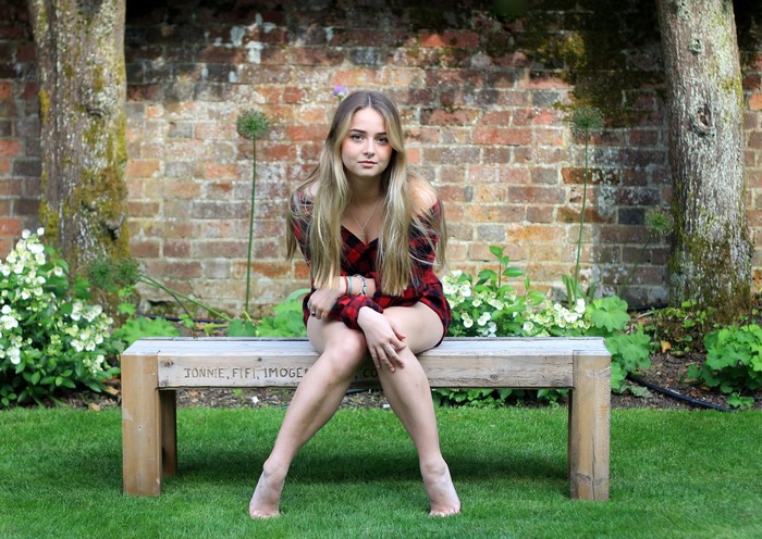 Connie Sitting on Wooden Bench in Garden