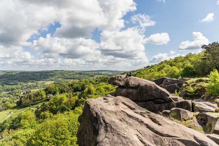 Person sitting on rocks overlooking Cromford, England