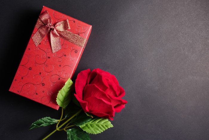 Red gift box with bow and red rose