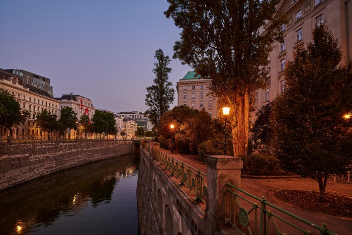 Vienna canal at dusk with street lights and buildings