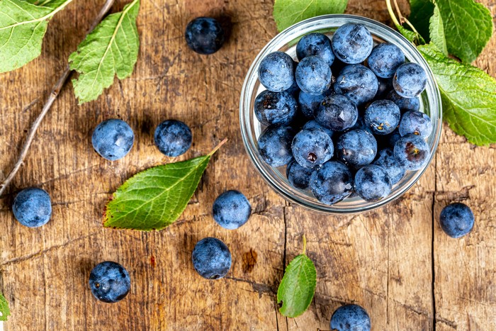 Blueberries in a bowl on wood planks