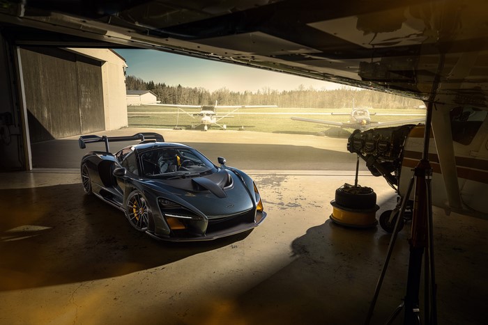 McLaren Senna in a hangar with airplanes