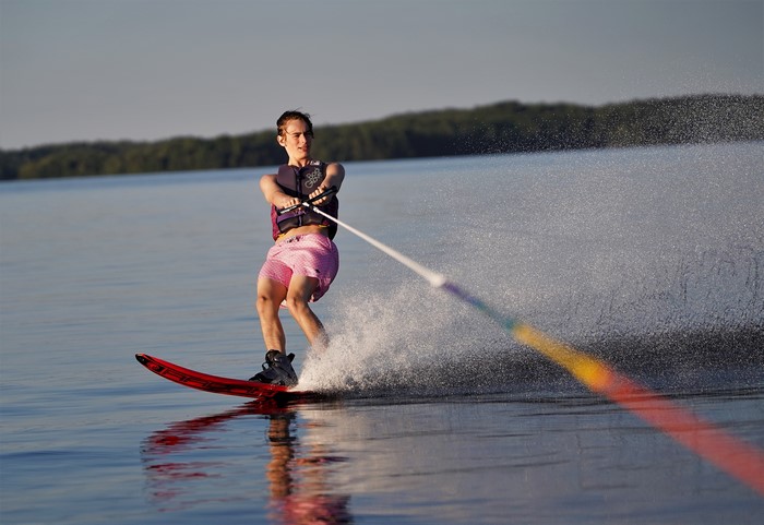 Man water skiing with water splash