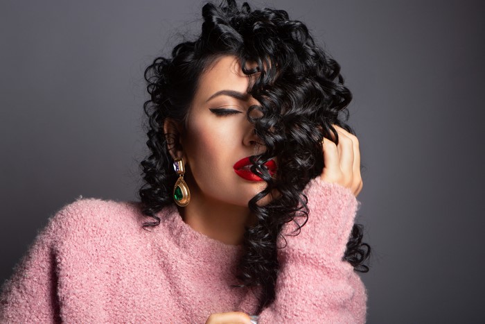 Brunette woman with curly hair and red lipstick