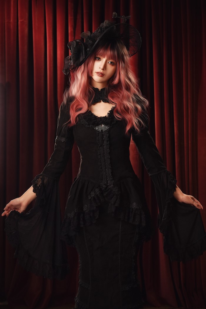 Woman in black gothic dress and hat