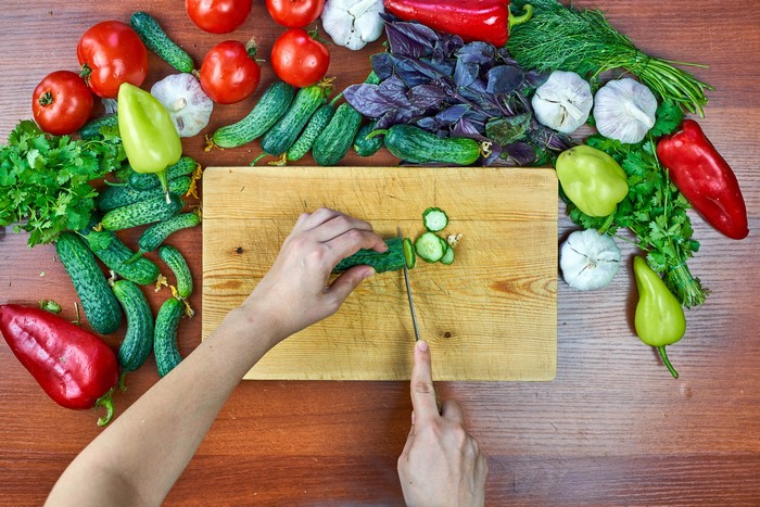 Vegetables on a wooden table with a cutting board