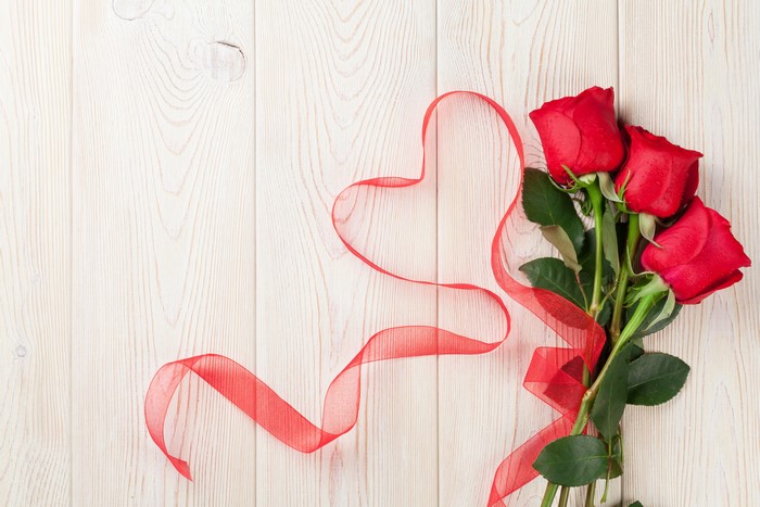 Red Roses and Ribbon Heart on Wood Planks