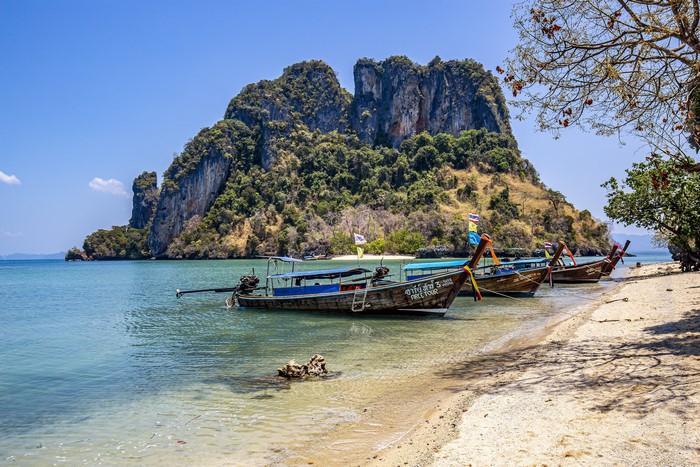 Longtail boats on a tropical island coast in Thailand