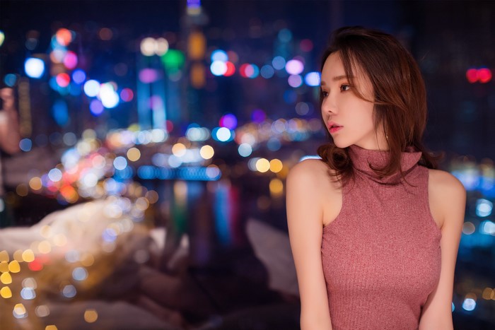 Asian Woman with Brown Hair and City Bokeh Nightscape