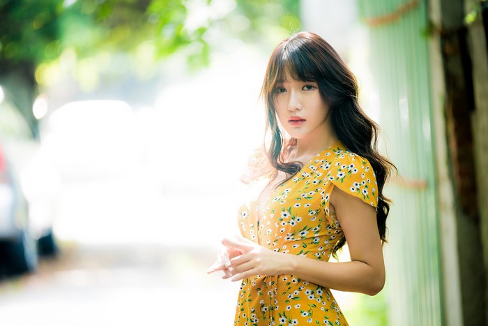 Asian woman in yellow floral dress