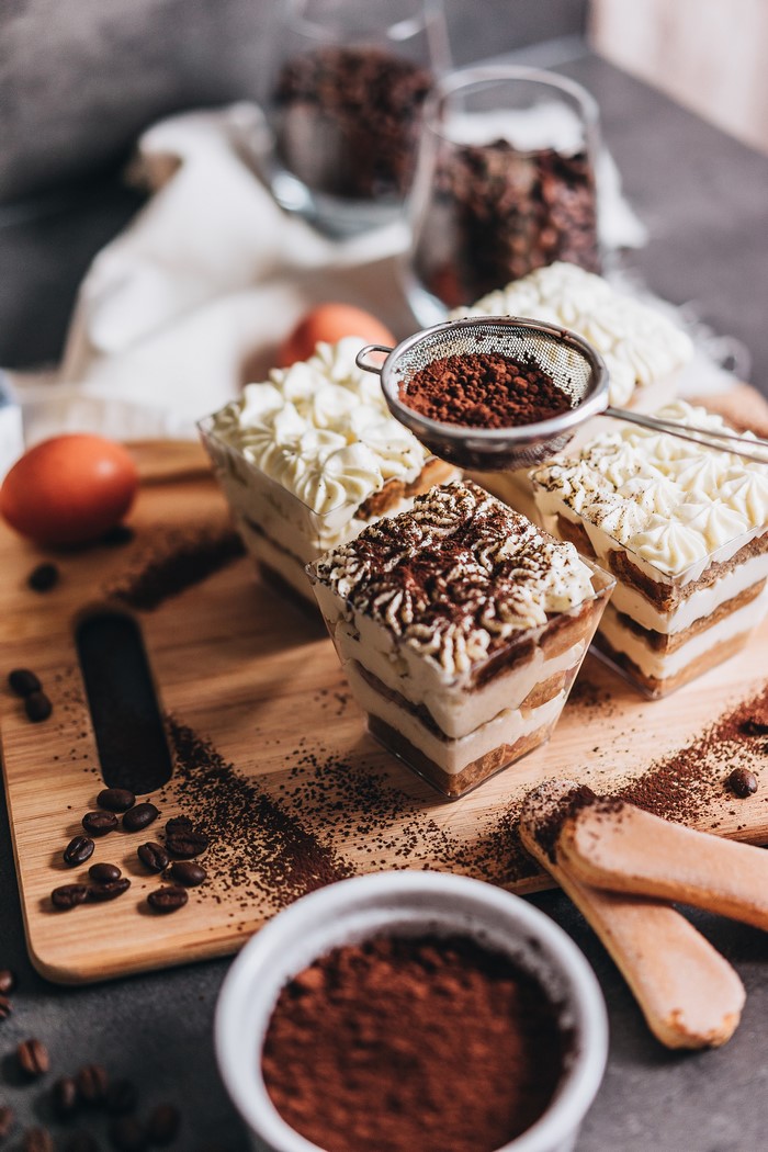 Tiramisu desserts with cocoa powder and coffee beans