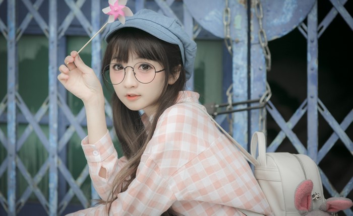 Asian girl with glasses and pinwheel