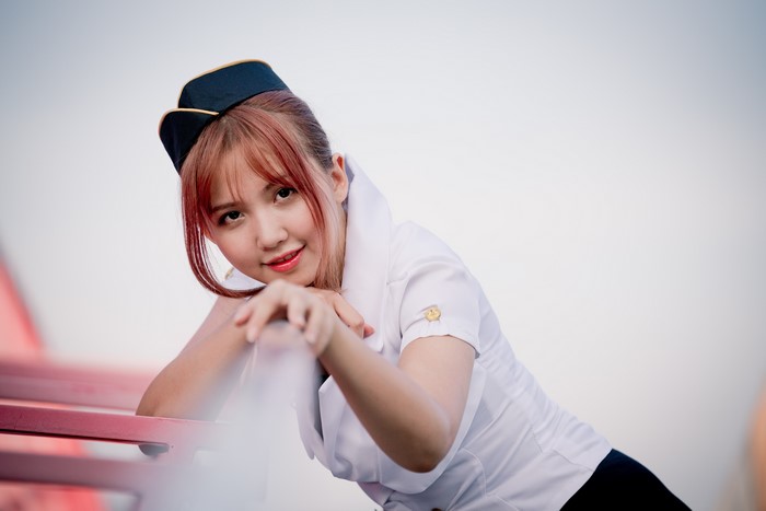 Asian stewardess with red hair and a smile