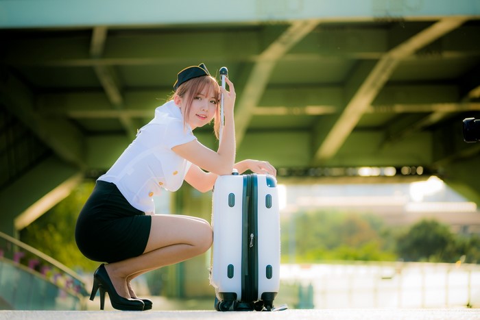 Asian stewardess with suitcase