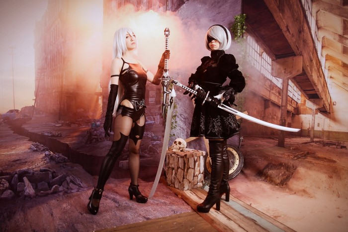 Two women cosplaying as Nier: Automata characters with swords