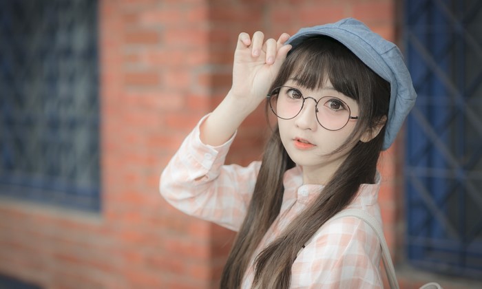 Asian girl with glasses and baseball cap