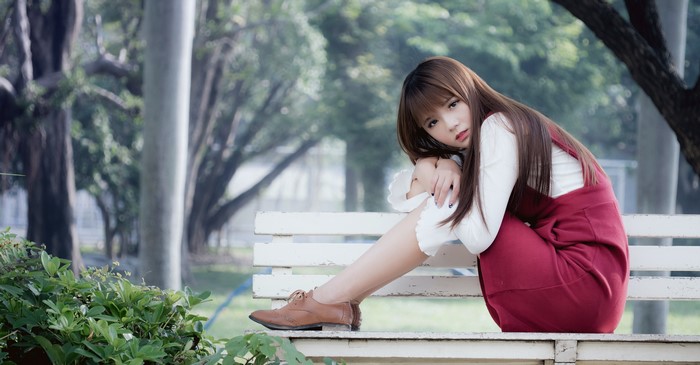 4K Asian Woman Sitting on White Bench