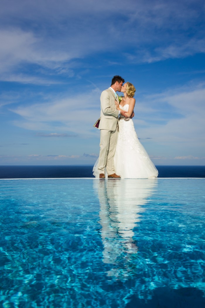 Bride and Groom kissing by a pool