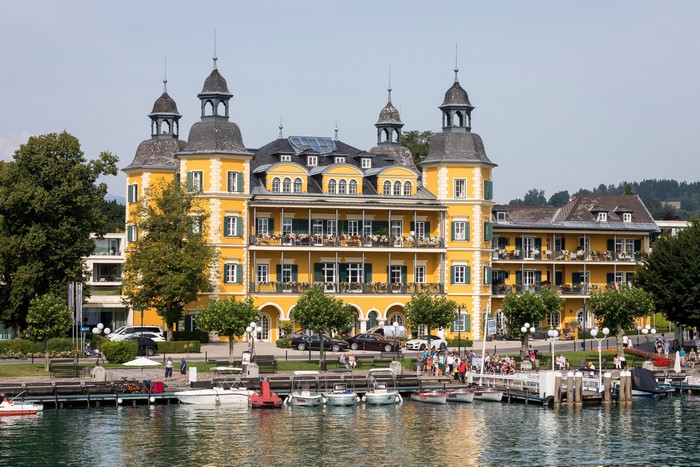 Yellow hotel building on a lake in Austria