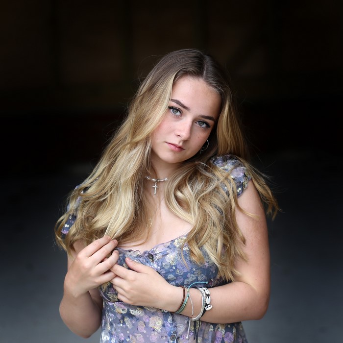 Connie with dark blonde hair wearing a floral dress