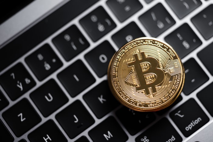 Bitcoin coins on a laptop keyboard