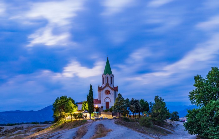 Church on a hill at dusk with clouds