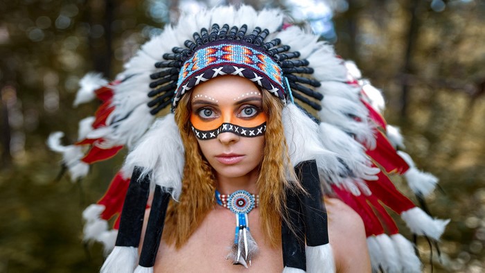 Woman in Native American Headdress with Face Paint
