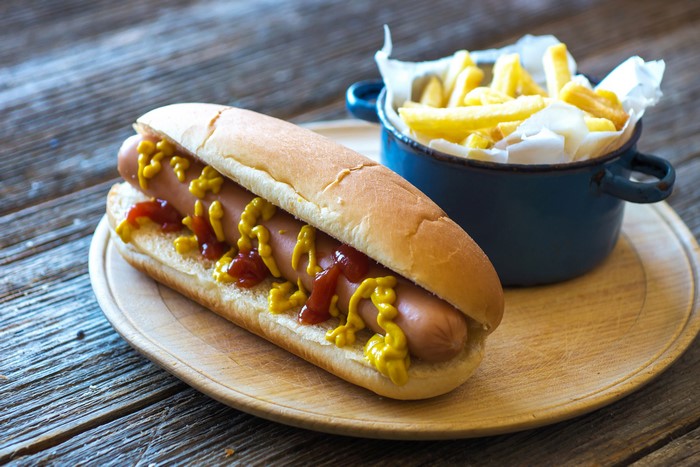 Hot dog with ketchup and mustard, served with french fries