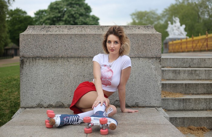 Woman in T-shirt and Skirt with Roller Skates