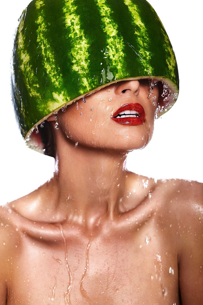 Woman with watermelon on head, water drops