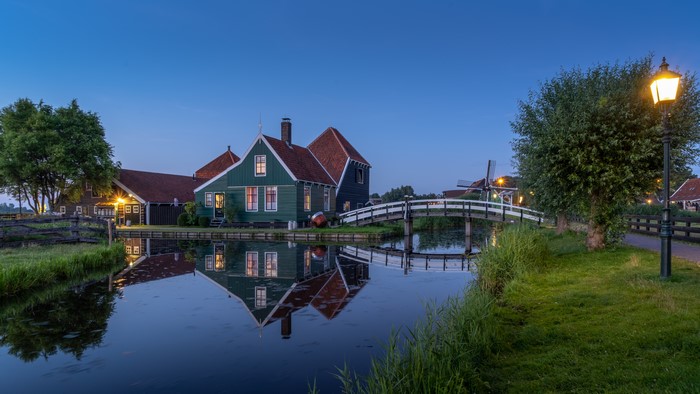 Houses and bridge over canal in Zaandam, Netherlands at dusk