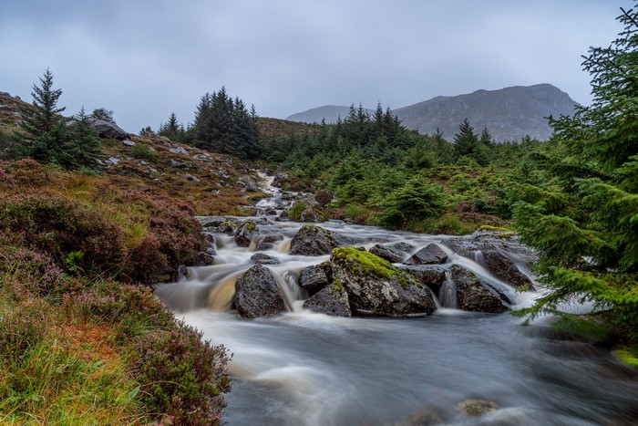 Stream flowing over stones in Stadlandet, Norway