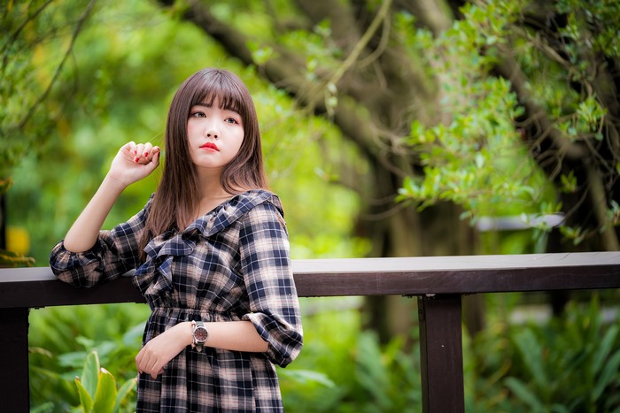 Asian girl in plaid dress with watch