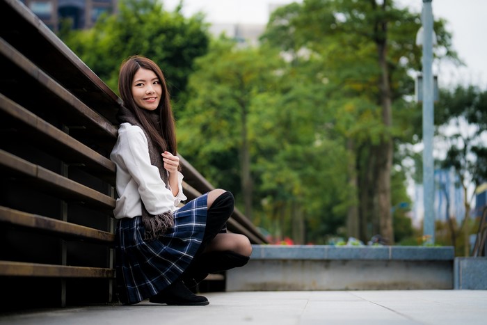 Asian woman sitting on a bench