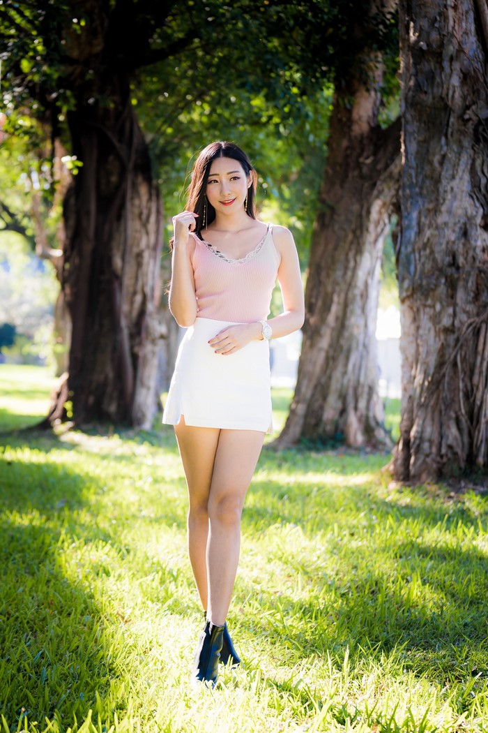 Asian Woman Smiling in Skirt and Singlet