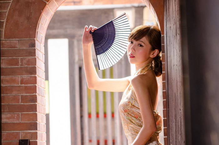 4K Asian Woman Holding Hand Fan in Archway