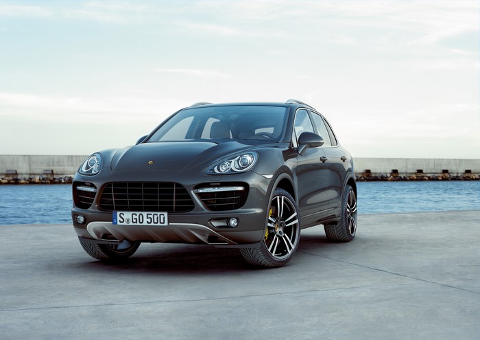 Grey Porsche Cayenne parked by the water