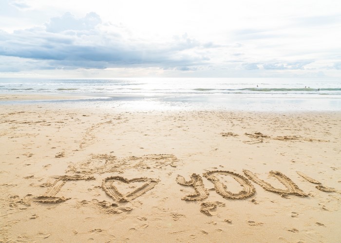 I love you written in sand on a beach
