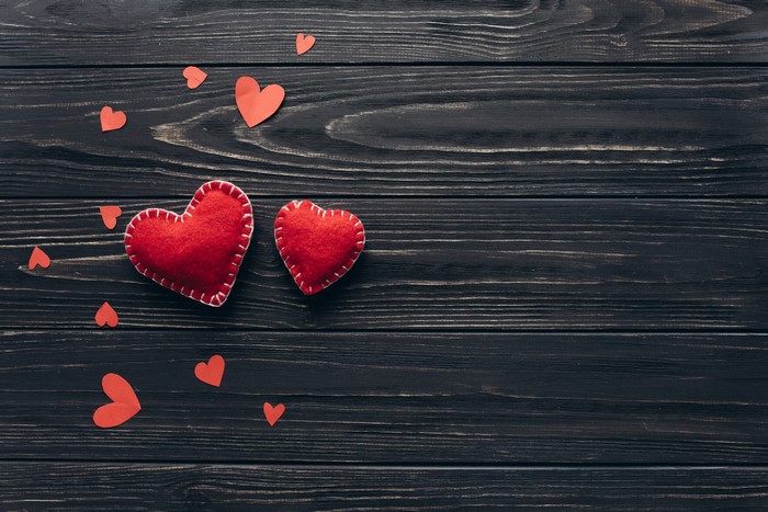 Valentine's Day hearts on dark wood planks