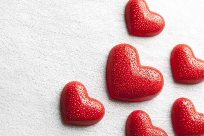 Red Hearts with Water Drops on Textured Surface