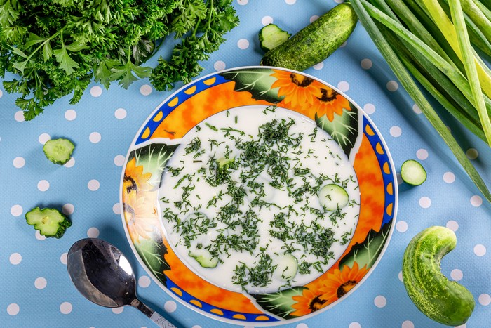 Okroshka soup with cucumbers and dill on a plate