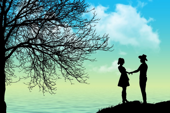 Couple holding hands under a tree silhouette