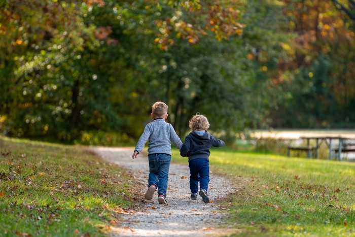 Two Boys Walking on a Trail in Autumn