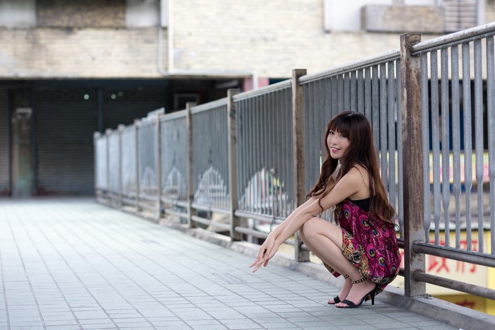 4K Asian Woman Sitting by Fence