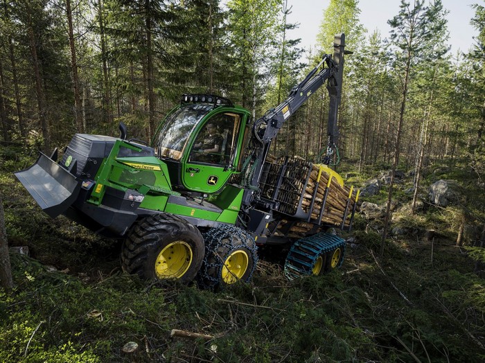 John Deere 1010G Forwarder carrying logs in forest