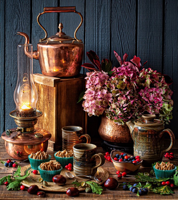 Still-life with copper kettle, hydrangea, and cupcakes