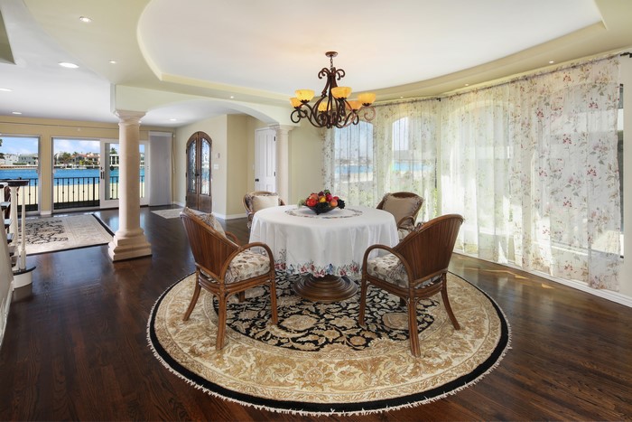 Dining room with table, chairs, chandelier, and carpet