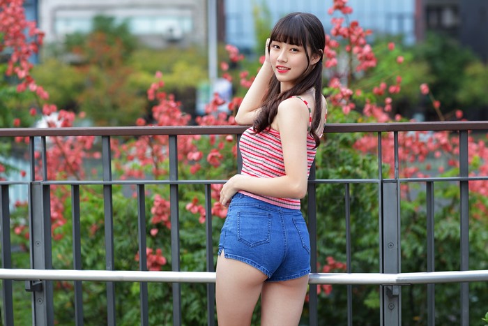 4K Asian Woman Posing By Fence