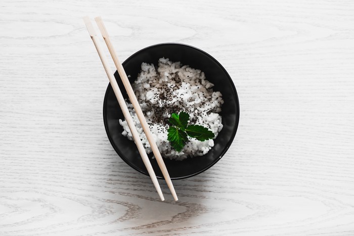 Rice in a bowl with chopsticks