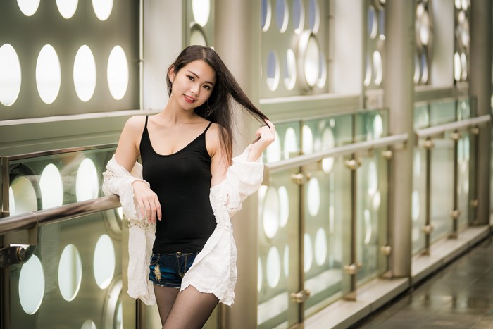 Asian woman in singlet and shorts posing